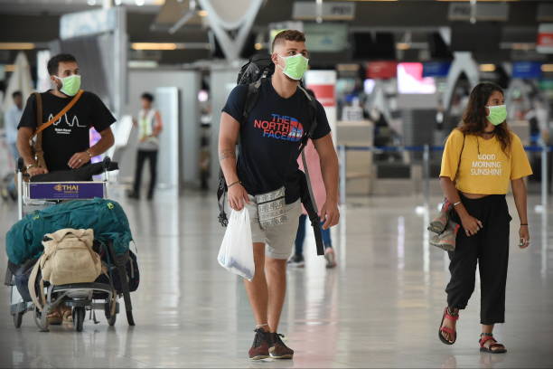 Air Travelers Wear Masks as a Precaution against Covid-19 stock photo