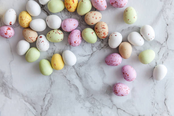 istock Happy Easter concept. Preparation for holiday. Easter pastel candy chocolate eggs sweets on trendy gray marble background. Simple minimalism flat lay top view copy space 1211652402
