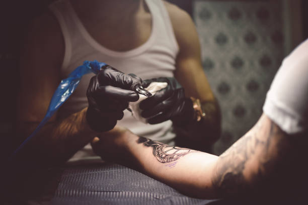 istock Artist tattooing a man in studio 1211652790