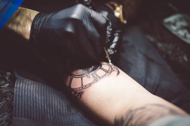 istock Artist tattooing a man in studio 1211653515