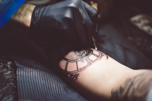 istock Artist tattooing a man in studio 1211653520