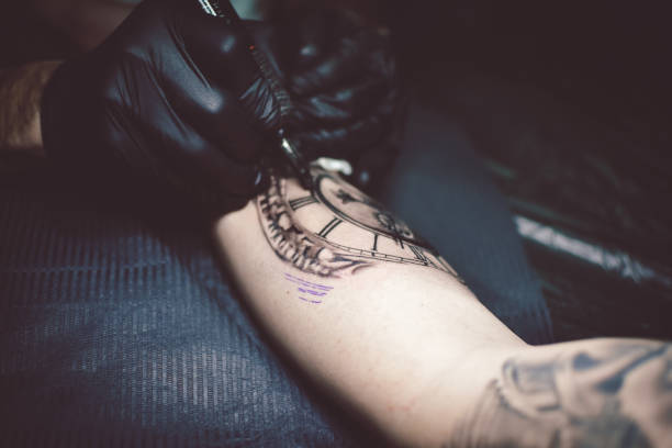 istock Artist tattooing a man in studio 1211653904