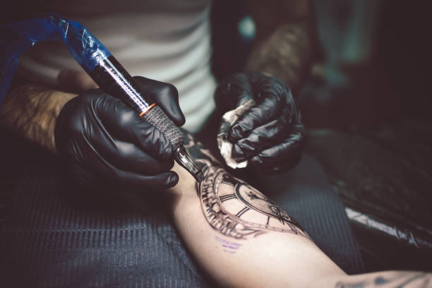 istock Artist tattooing a man in studio 1211653908