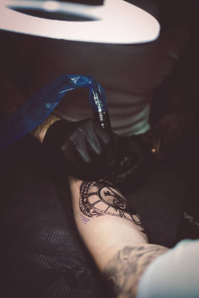 istock Artist tattooing a man in studio 1211654520