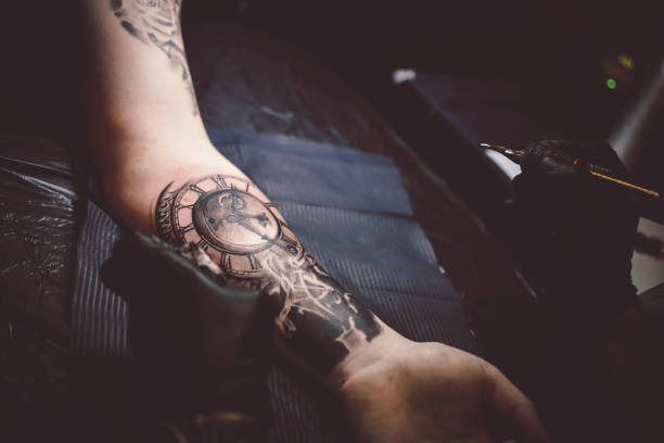 istock Artist tattooing a man in studio 1211654654