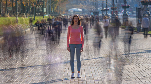 istock The young woman stands in crowdy flow 1211656082