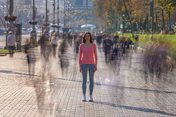 istock The young woman stands in crowdy flow 1211656084