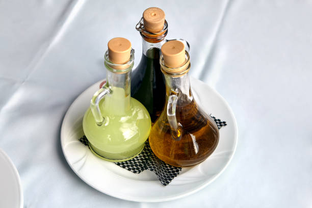 istock Three glass bottles with dressing for food. 1211660187
