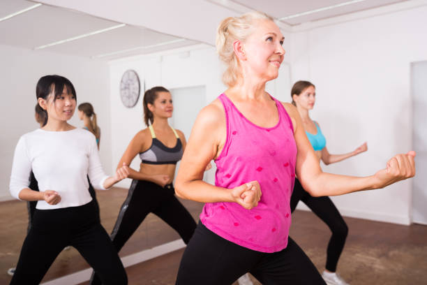 istock Ordinary active females exercising dance moves 1211661194