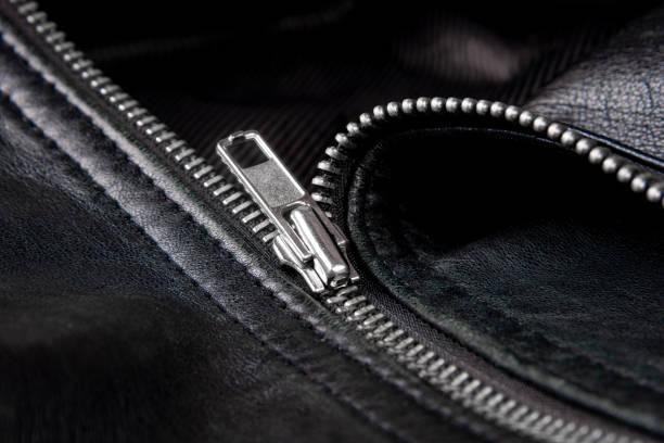 Iron zipper on a black leather jacket, needlework concept.