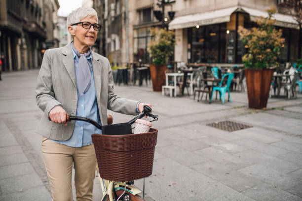 istock Senior woman going downtown with her bike 1211663214