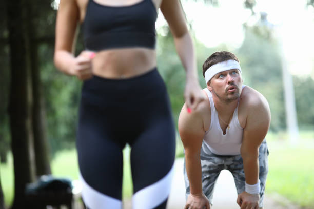istock Tired guy does not have time to run with girl. 1211663258