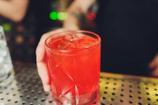 istock Bartender adding spices into the fresh and sweet strawberry mojito summer cocktail with a smoke note on the dark background. 1211663405