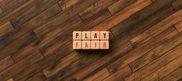 Photo of cubes with the message PLAY FAIR - 3D rendered illustration