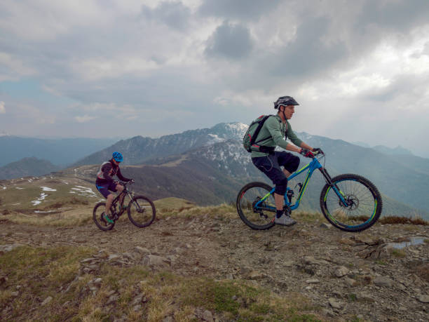 istock Mountain bikers ride up snowy ridge line 1211664910