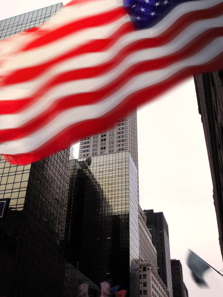 istock Low angle Manhattan view with American flag 1211670702