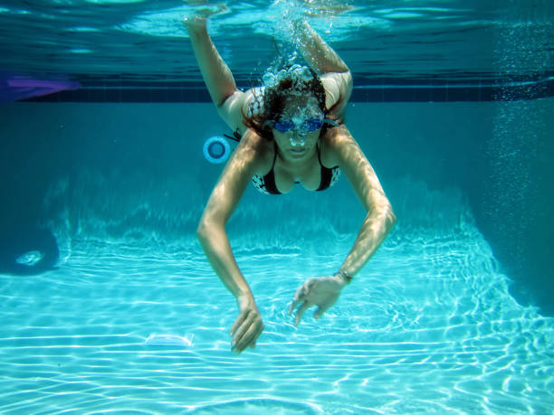 istock young woman swimming underwater 1211671318