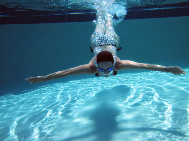 istock young woman swimming underwater 1211671377