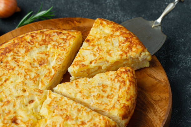 istock Spanish omelette with potatoes and onion, typical Spanish cuisine. Tortilla espanola. Rustic dark background 1211671445