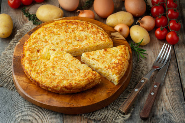 istock Spanish omelette with potatoes and onion, typical Spanish cuisine. Tortilla espanola. Rustic dark background 1211671446