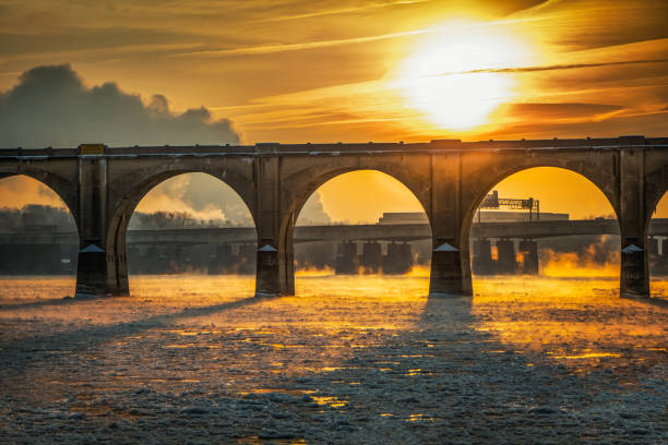 Icy Susquehanna River and a railroad bridge in Harrisburg, Pennsylvania A blazing sun roars over an ice-filled Susquehannah River in Harrisburg, PA harrisburg pennsylvania stock pictures, royalty-free photos & images