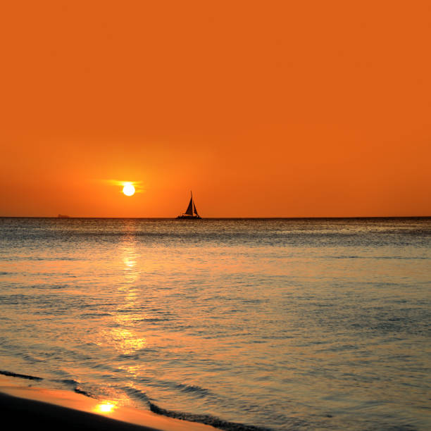 istock sailboat over orange color sunset sky 1211673416