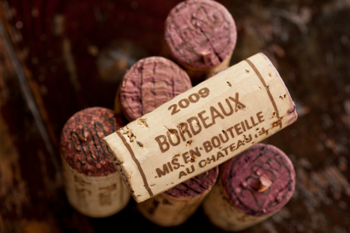 Close up shot of a collection of generic corks from Bordeaux red wine region, focus on one object