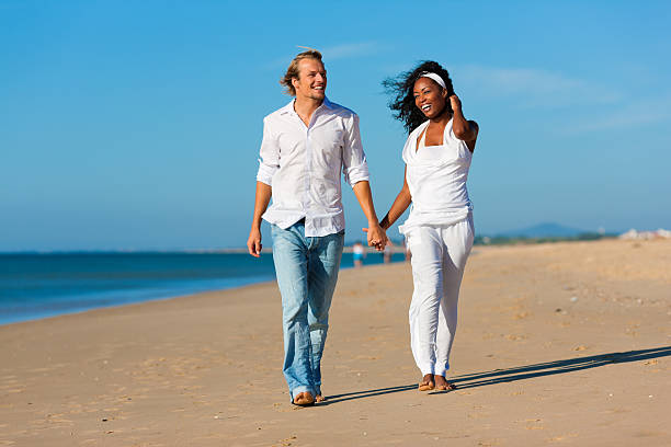 istock Happy couple walking and running on beach 121167898