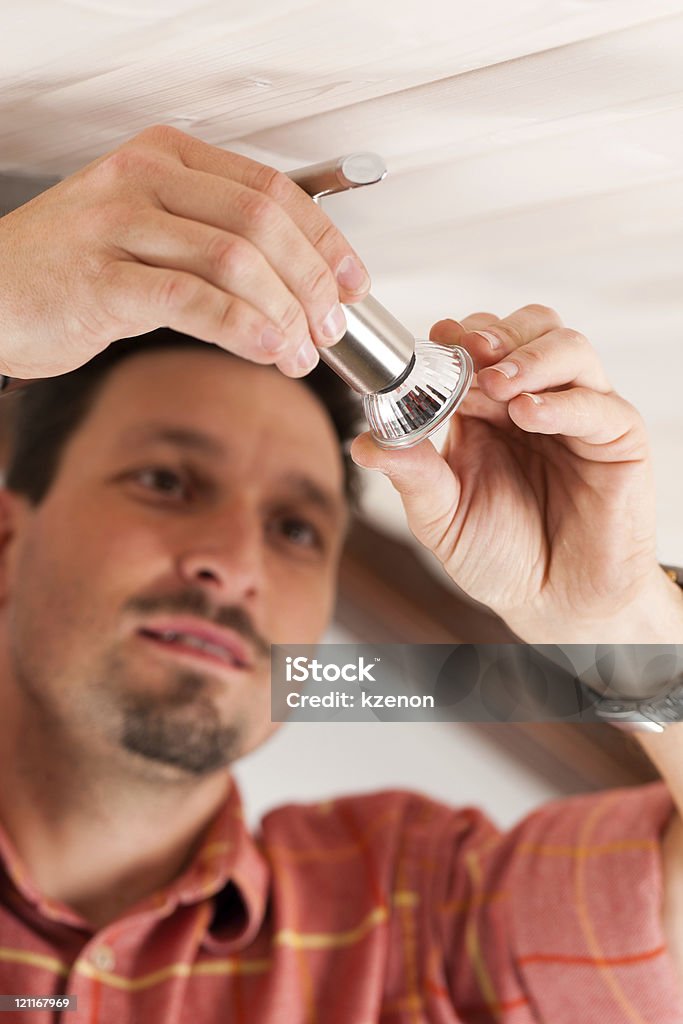 Worker is installing a luster  Adult Stock Photo
