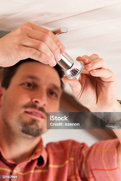 Worker Is Installing A Luster Stock Photo - Download Image Now - Adult, Blue-collar Worker, Ceiling