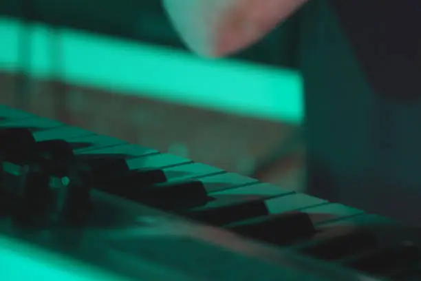 Photo of Part of the keyboard of a synthesizer standing on the stage during a performance