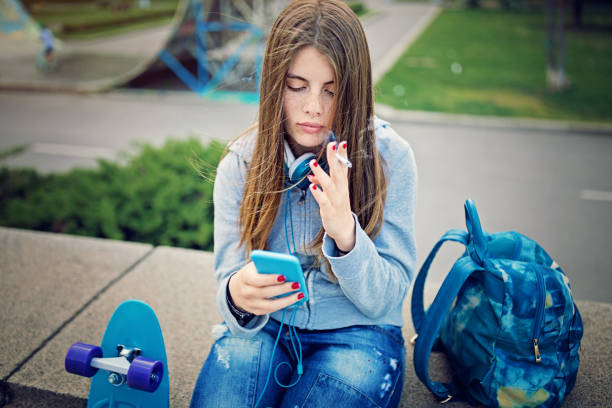 Sad young girl is smoking at the front of skateboard ramp Sad young girl is smoking at the front of skateboard ramp cigarette photos stock pictures, royalty-free photos & images