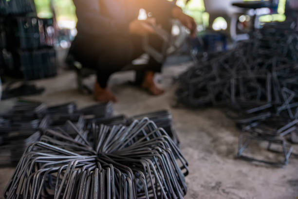 LUANG PRABANG, LAOS - OCTOBER 8: An unidentified man stirs coals and heats up metal at a forge in Luang Prabang, Laos on October 8, 2017.