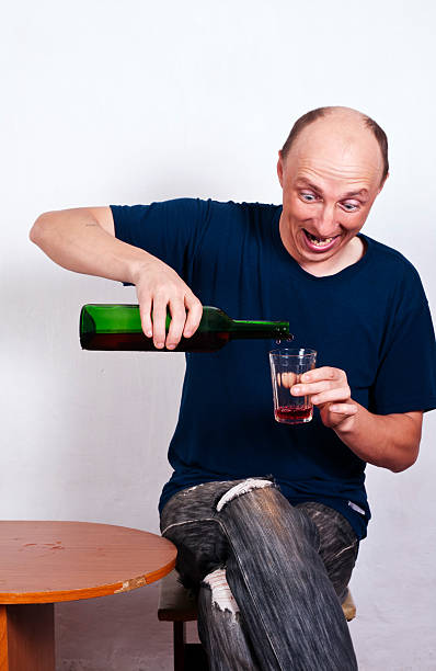 男性に注ぐワイングラス - eastern european caucasian one person alcoholism ストックフォトと画像