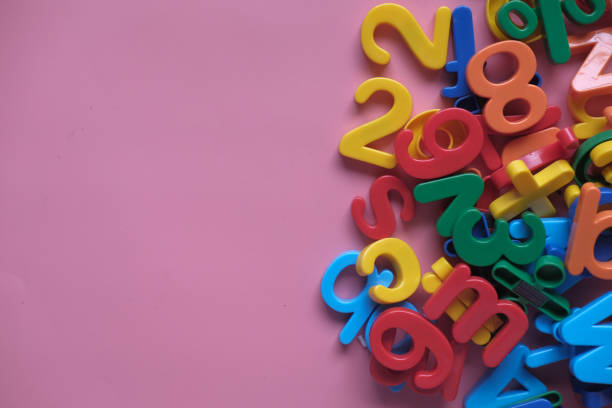 istock colorful alphabet on a pink background , close up 1211694708