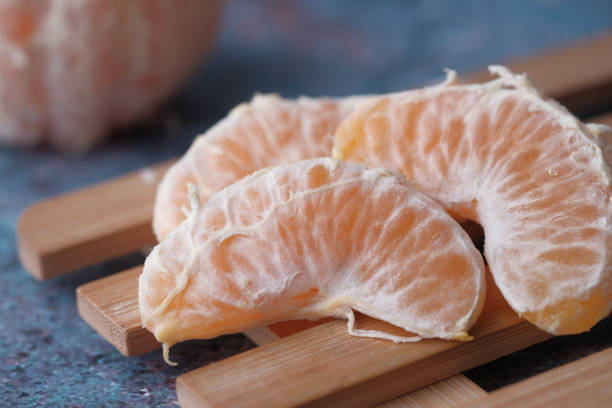 close up of slice of orange fruit on table
