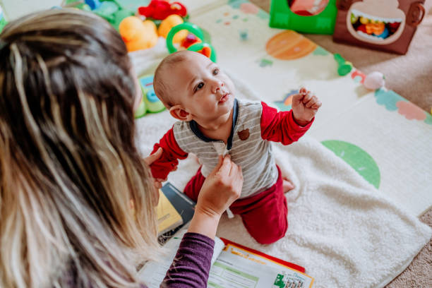 istock Multitasking mother taking care of her baby boy while trying to study 1211700391
