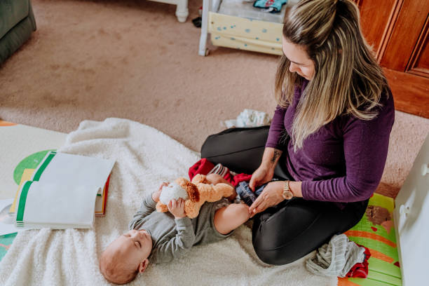 istock Multitasking mother taking care of her baby boy while trying to study 1211700428