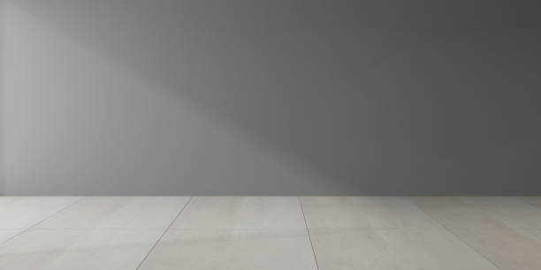 istock Mock-up of dark empty room and marble tile floor with sun light cast shadow on the grey wall,Perspective of minimal interior design. 3D rendering 1211706436