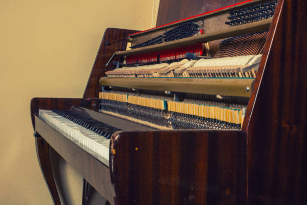 istock old broken piano standing at the wall 1211707332