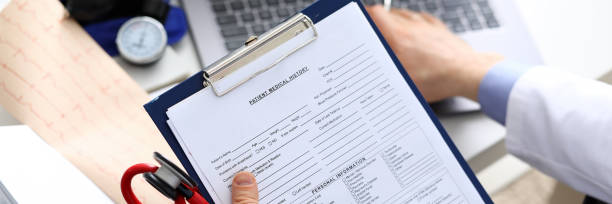 istock Filling out patient medical history, personal data 1211707625