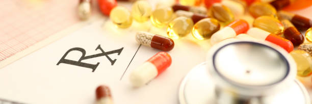 istock Pile of tablets lying over prescription application form 1211708695
