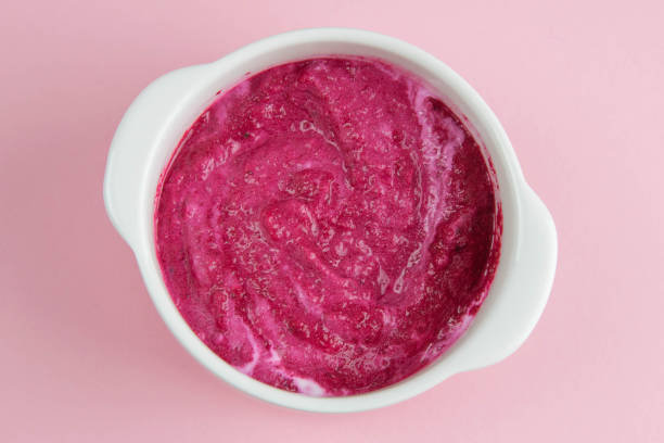istock Curd yogurt with strawberries and raspberries jam isolated on pink background 1211711696