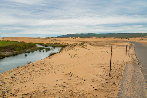 Sand dunes, river and empty road, California