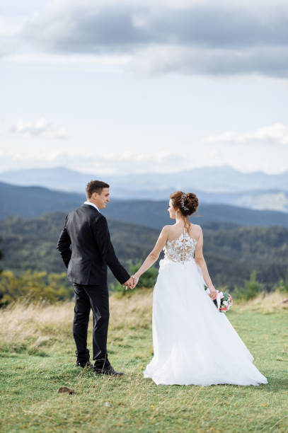 istock Beautiful bride and groom at the mountains 1211714256
