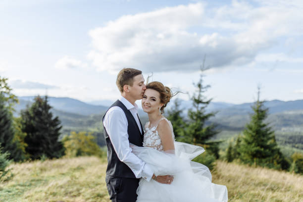 istock Beautiful bride and groom at the mountains 1211714360