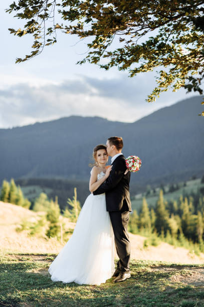 istock Beautiful bride and groom at the mountains 1211714905