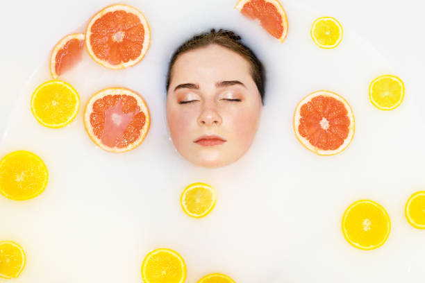 istock Pretty girl in bath with orange lemon. 1211716299