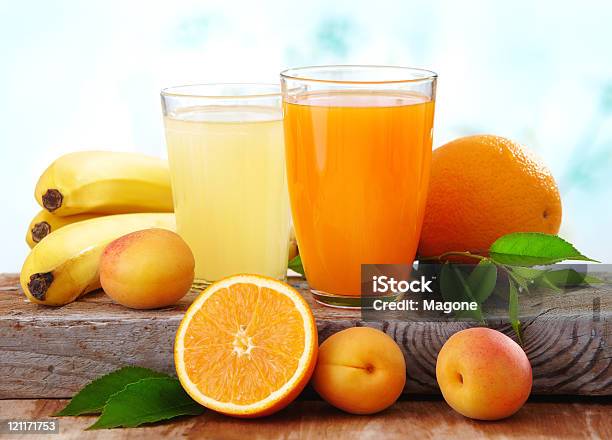 Two Glasses Of Fresh Juice And Fruits On The Table Stock Photo - Download Image Now - Apricot, Banana, Citrus Fruit