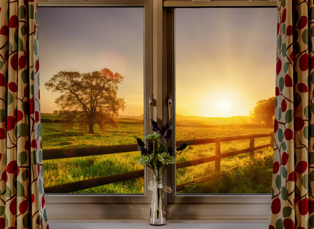 Window with stunning rural sunset view stock photo